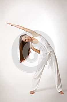 Woman in triangle Yoga posture (Trikonasana)