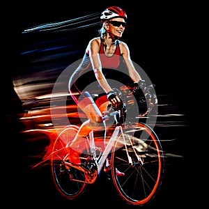 Woman triathlon triathlete cyclist cycling isolated black background photo
