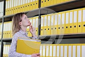 Woman tries to remember position of folder with papers