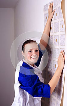 Woman tries on wall-papers to wall