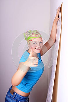 Woman tries on wall-papers to wall