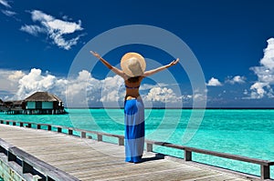 Woman on a beach jetty at Maldives