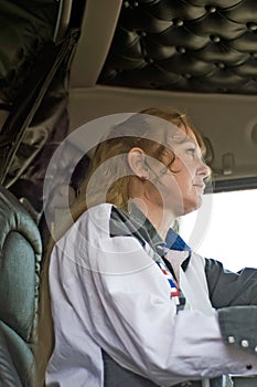 Woman Truck Driver Watching Traffic Ahead of Her