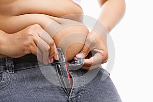 Woman trying hand to zipper her jeans