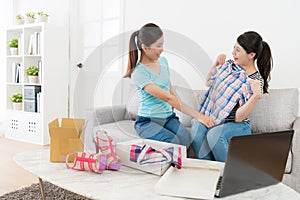 Woman trying new shirt checking whether suitable.