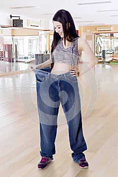 Woman trying old jeans after weight loss