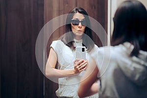 Woman Trying on Outfit Taking a Selfie in a Changing Room Mirror