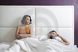 Woman Trying Sexual Approach With Man In Home Bed