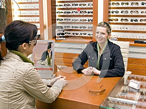 Woman trying on spectacles.