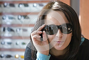 Woman trying on sunglasses