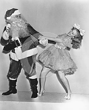 Woman trying to dance with Santa Claus