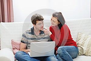 Woman trying to distract boyfriend from laptop