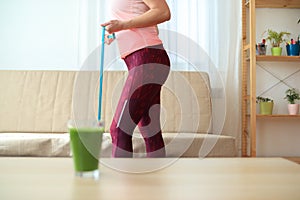 A woman trying to lose weight at home with training