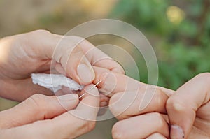 The woman is trying to pull the splinter out of the child's hand