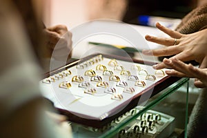 Woman trying wedding rings at a jeweller