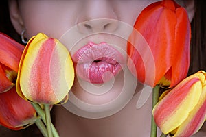 Woman with tulips kiss. Sensual lips. Kissing. 8 march women`s day.