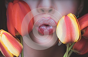 Woman with tulips kiss. Sensual lips. Kissing. 8 march women's day.