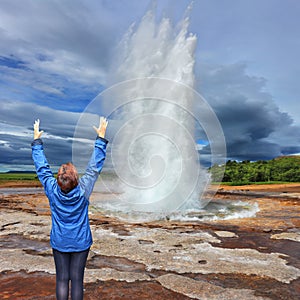 Woman - turist delighted geyser