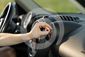 Woman turn on air conditioner in car at vehicle panel grid cooling system. Automobile conditioning