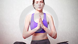 The woman turns on the music on the phone for meditation to relax and dive into Zen. Quarantine Yoga Class Online