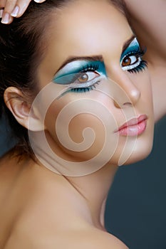 Woman with turquoise make-up.