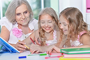 Woman with tweenie girls doing homework