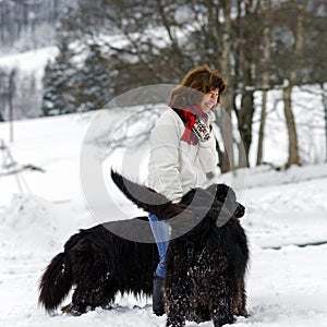 Woman with two big water-dogs in snow