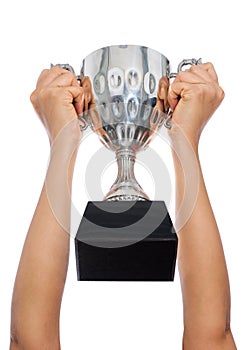 Woman two hand holding a champion silver trophy on white backgro