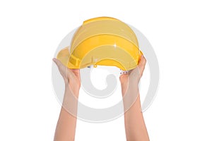 Woman two hand holding a hardhat, helmet isolated