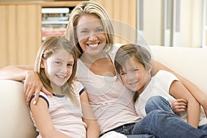 Woman and two young children in living room