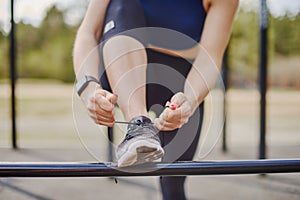 Woman tying her shoelaces during outdoor training