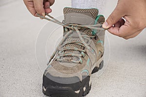Woman Tying Shoe on concrete