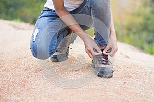 Woman tying shoe laces, Closeup of female tourist getting ready