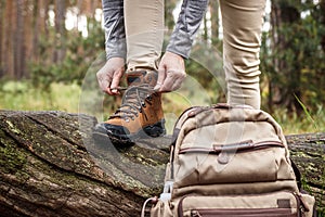 Woman tying shoelace on her hiking boot
