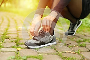 Woman tying shoelaces on her sneakers