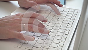 Woman typing on computer keyboard - close up