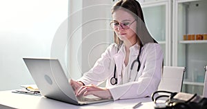 Woman is typing a doctor on a keyboard on a laptop