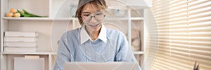 Woman typing in front of a laptop, Hand pressing laptop keyboard