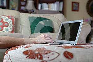 Woman typing on her laptop at her home. Work from home or flexi work concept photo