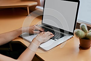 Woman Typing on Her White Laptop Computer At Working Desk