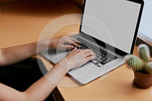 Woman Typing on Her White Laptop Computer At Working Desk