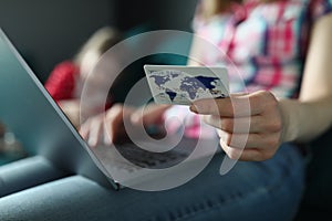 Woman typing on keyboard, holding credit card, pay online remotely, shopping on laptop from home