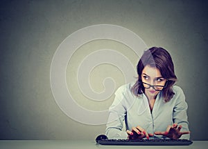 Woman typing on the keyboard wondering what to reply photo