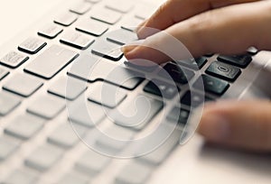 Woman typing on keypad