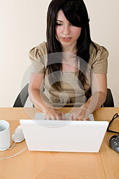 Woman typing on a laptop