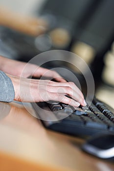 Woman typing on a laptop