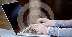 Woman typing on a laptop computer