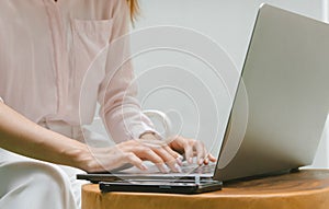 Woman typing on laptop computer. Online internet marketing, freelance, working from home, online education