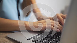 Woman typing on laptop keyboard in the office. Close up woman hands writing on laptop computer keyboard.