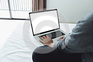 Woman typing laptop keyboard showing white screen